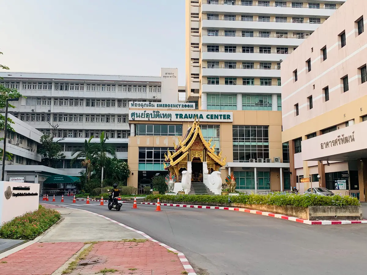 Hospital road with red and white kerbs leading to a building signed Trauma Center