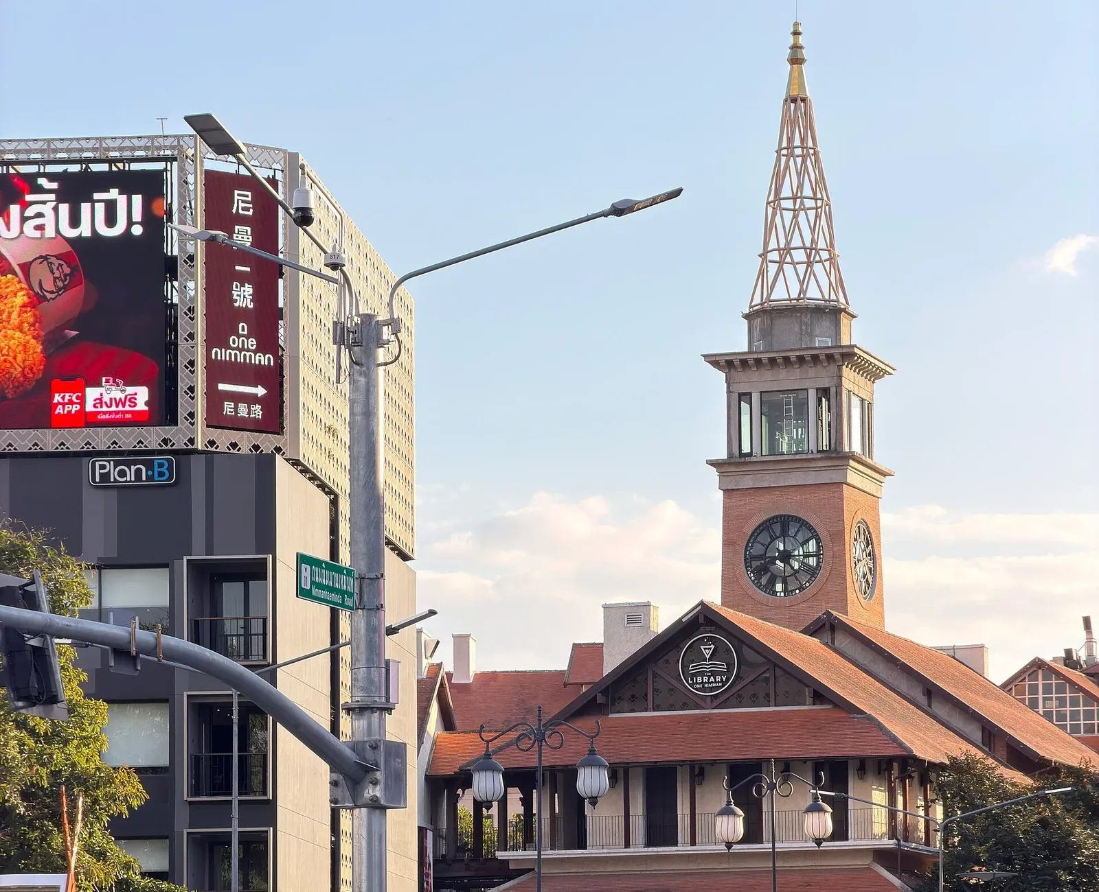 Street corner with a brick clock tower and traffic lights
