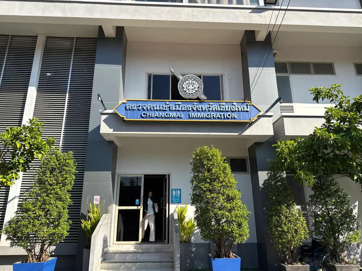 Front of a white two-storey government building with a signboard above a small entrance porch.